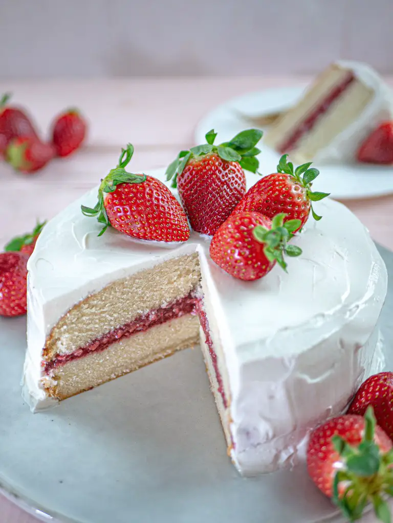This easy vegan vanilla cake is filled with a delicious homemade strawberry...