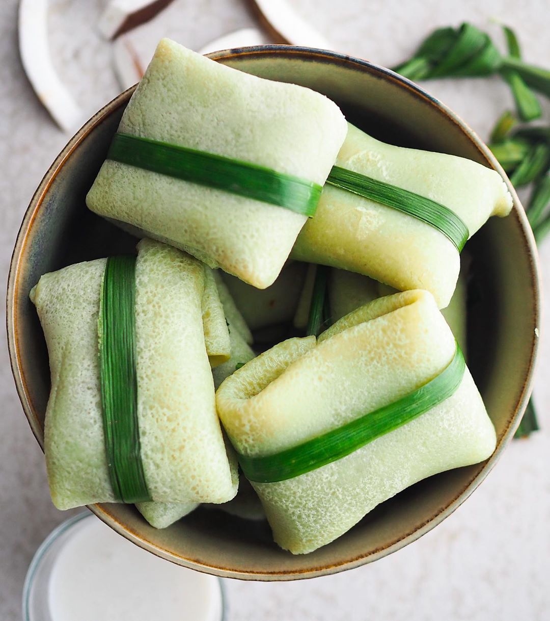 Vegan Pandan Crepes with Sweet Coconut recipe served in a bowl.