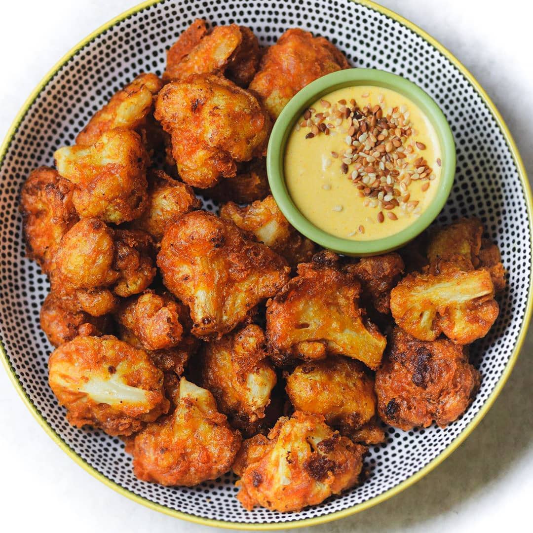 Beer Battered Spicy Cauliflower Wings recipe served in a bowl with dip.