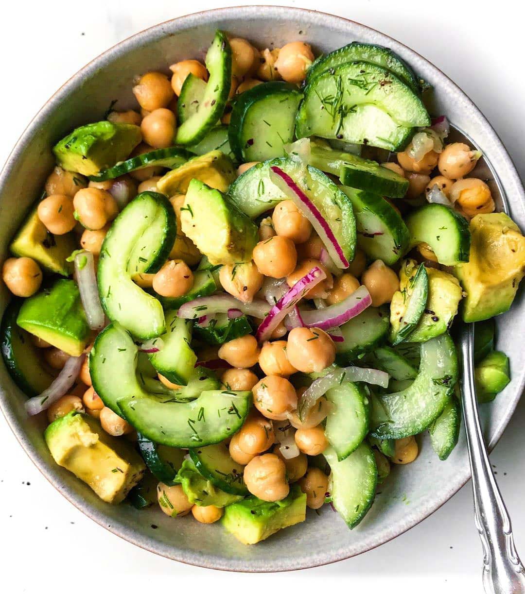 Chickpea Cucumber Salad recipe served in a bowl with spoon.