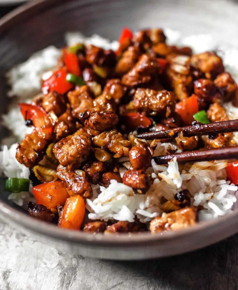 Kung Pao Tempeh recipe displayed in a bowl with chopsticks.