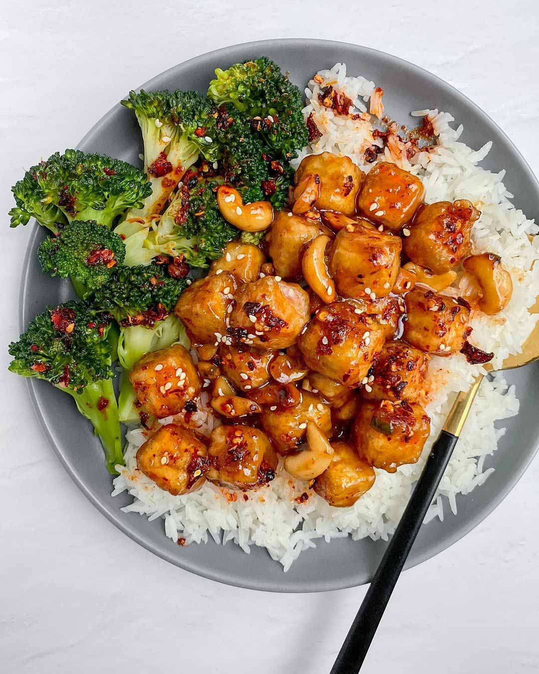 Sticky Cashew Tofu recipe served on a plate with rice and broccoli.