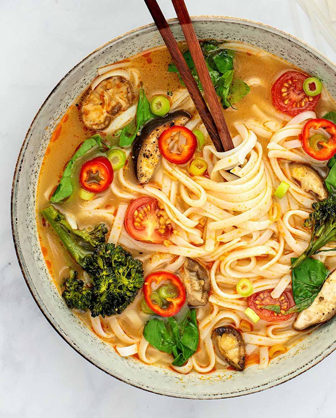 Thai Red Curry Lemongrass Soup recipe served in a bowl with chopsticks.