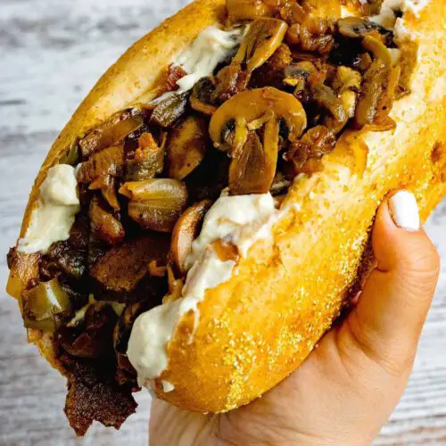 Vegan Philly Cheesesteak Sandwich recipe hold in hand.