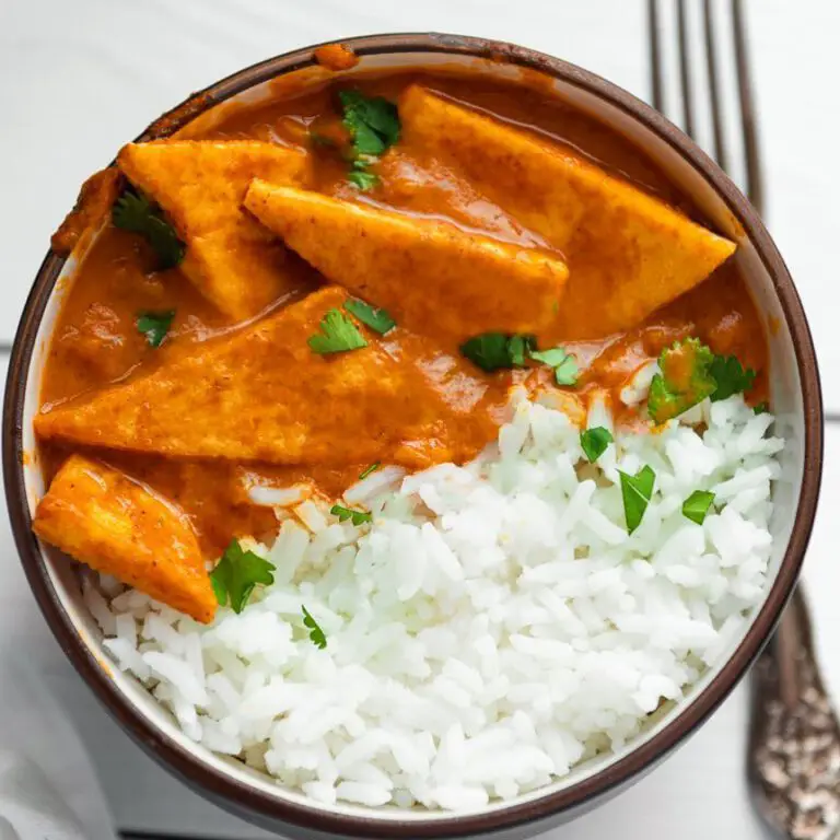 Easy Tofu Masala recipe served in a bowl with fork.