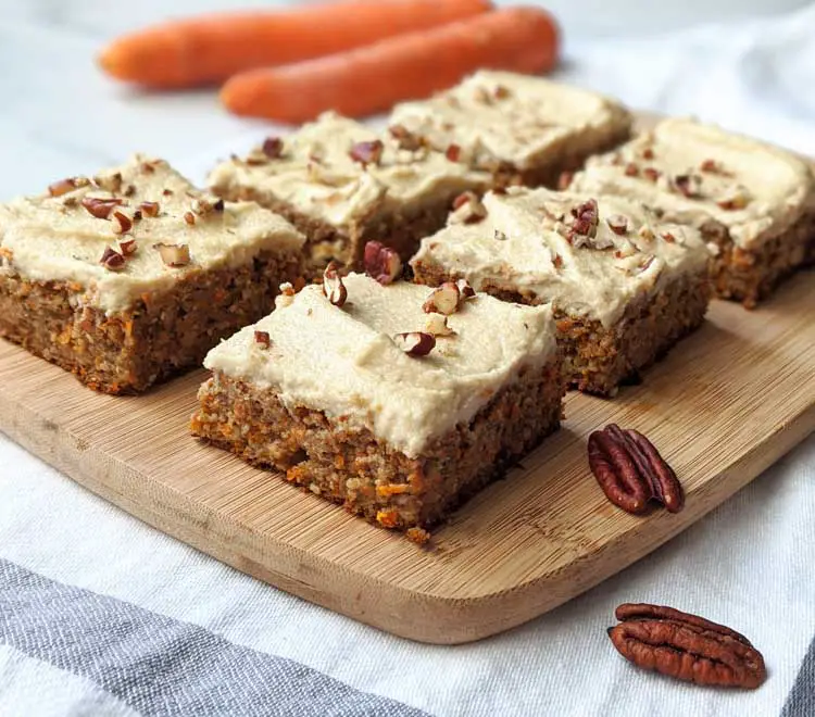 Healthy Vegan Carrot Cake recipe displayed on a wooden plate.