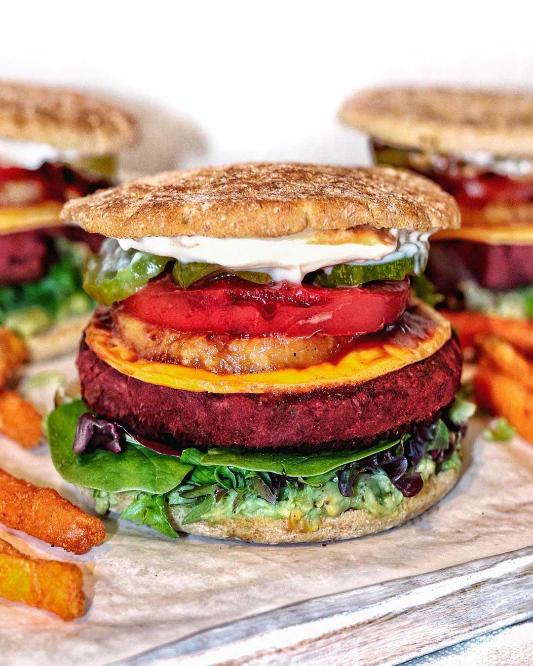 Roasted Beetroot Bean Burger recipe served on a plate with fries.