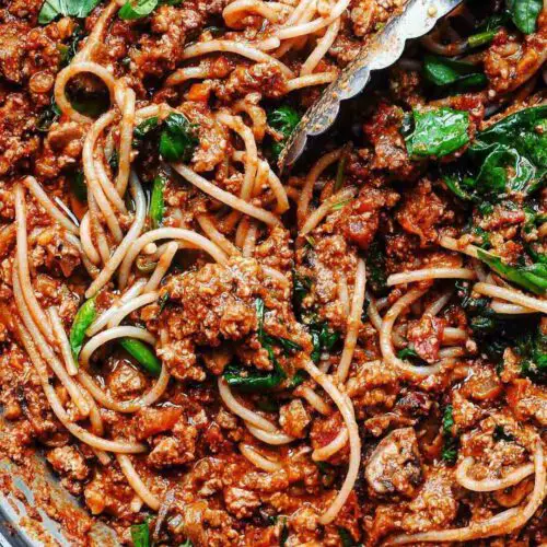 Spaghetti Bolognese with Walnut Tofu Meat recipe displayed in a large pan.