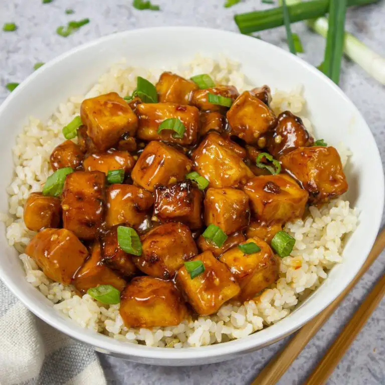 Sweet & Saucy Ginger Tofu recipe served in a bowl with rice.