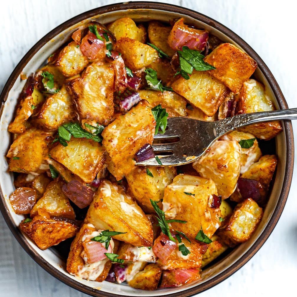 The Best Vegan Roasted Potatoes recipe served in a bowl with fork.