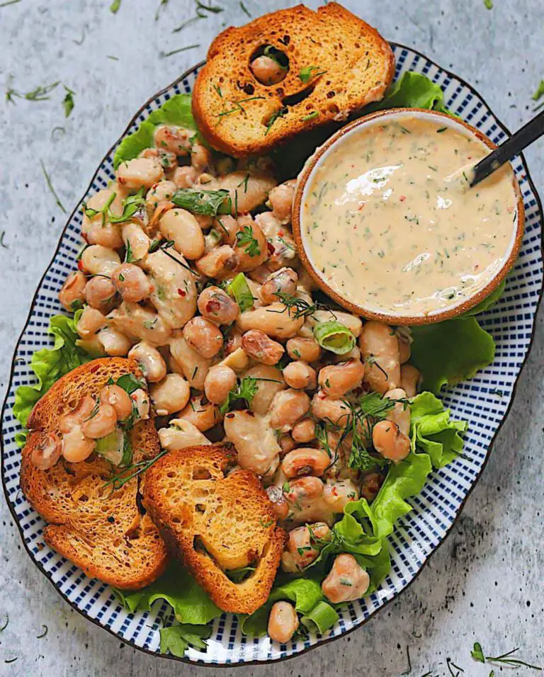 Two Bean Salad with Herby Tahini Dressing recipe served on a plate.