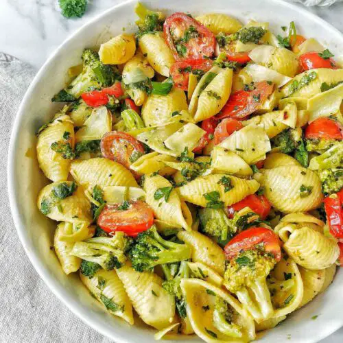 Vegan Cheesy Pasta With Broccoli & Tomatoes recipe served in a bowl.