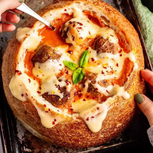 Vegan Meatball Parm Soup recipe served in a bowl of bread.
