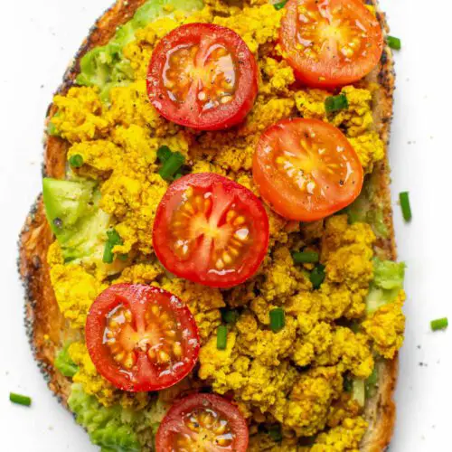 10-Minute Tofu Scramble recipe served on toast with tomatoes.