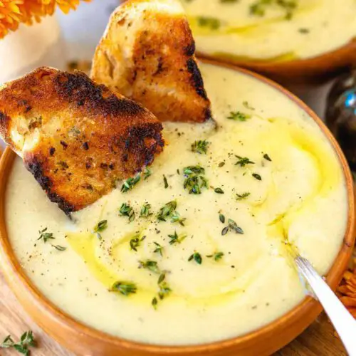 1-Pot Vegan Potato Leek Soup recipe served in a bowl with toasted bread.