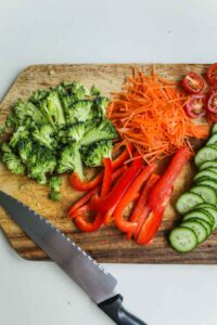 Vegetables on a cutting board with a knife