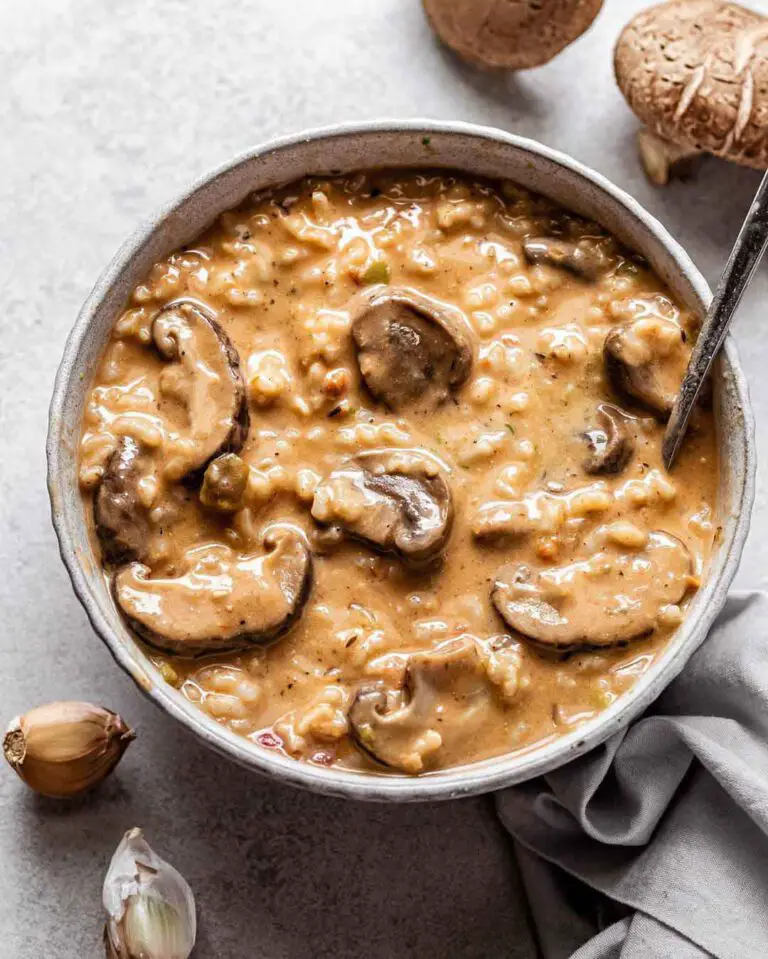 Creamy Rice & Mushrooms Soup recipe served in a bowl with spoon.