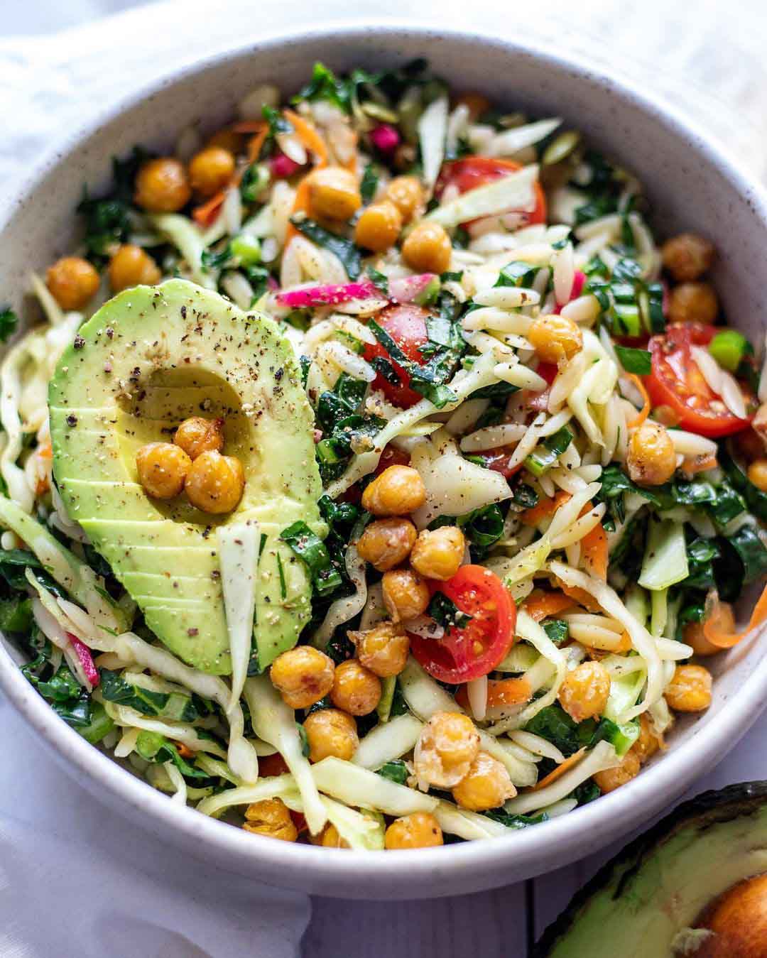 Vegan Winter Orzo Salad recipe served in a bowl with avacado.