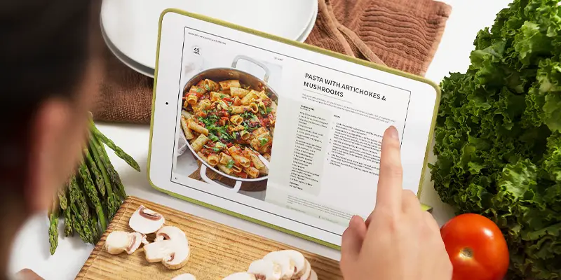 The Best Vegan Recipes eBook shown on iPad in kitchen.